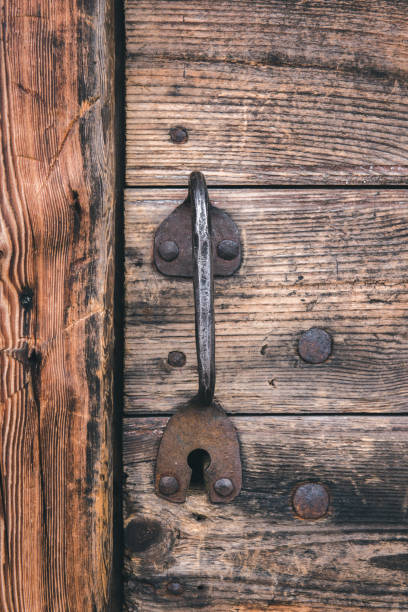 Metallic handle of door is in an old wooden house