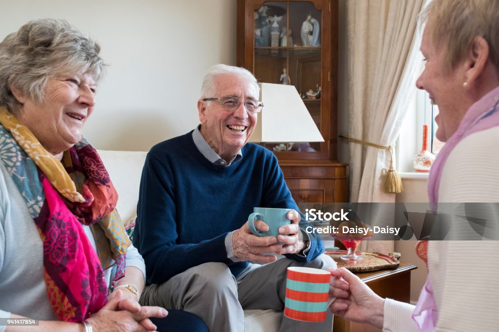 Groupe d’amis hauts réunion à la maison pour le café - Photo de Troisième âge libre de droits