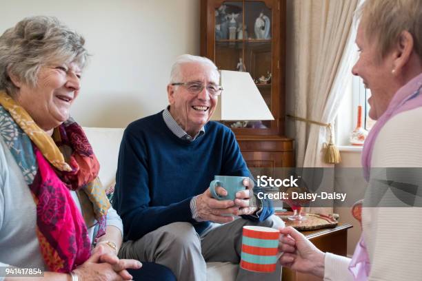 Group Of Senior Friends Meeting At Home For Coffee Stock Photo - Download Image Now - Senior Adult, Coffee - Drink, Domestic Life