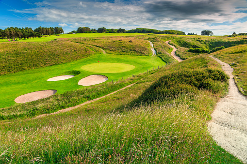 Stunning golf course with green fields and sand bunkers, France, Europe