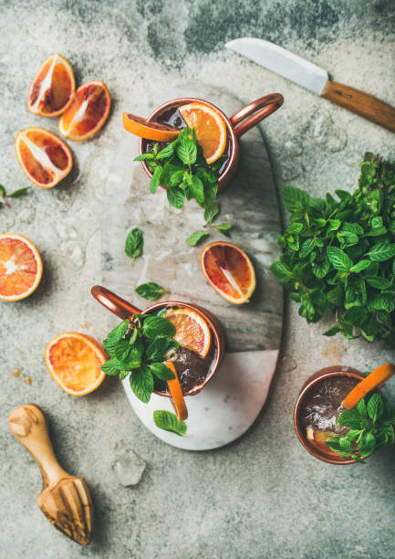 Blood orange Moscow mule alcohol cocktails in mugs, top view