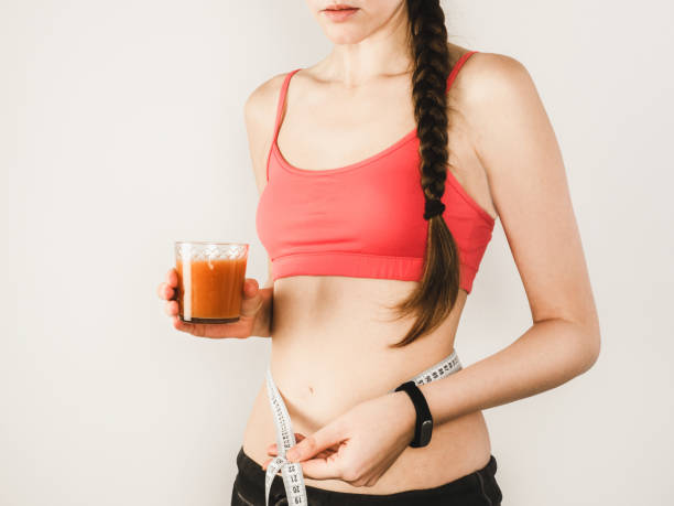 istock Stylish woman during exercises with dumbbells 941424444