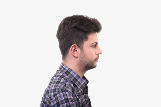 istock Profile view of young man looking away with blank facial expression over white background 941428492