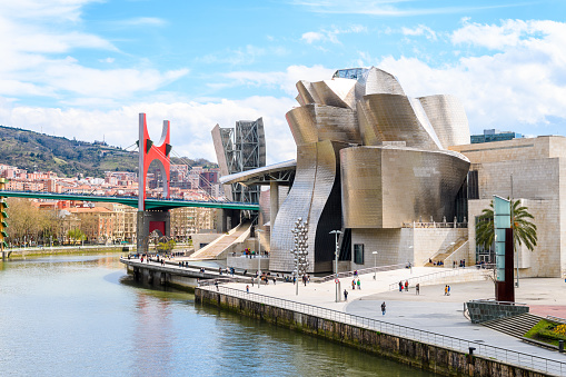 May 6,2022, Bilbao, Spain: A view across the Nervion River, with the Guggenheim Museum sitting on the river bank, on a quiet spring day in the late afternoon.