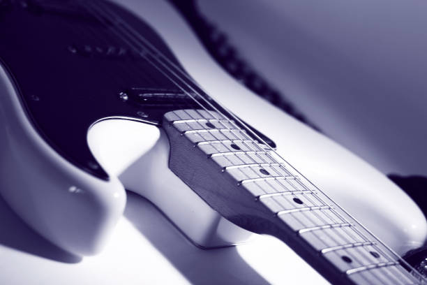 istock closeup.black guitar on a white background 941435314