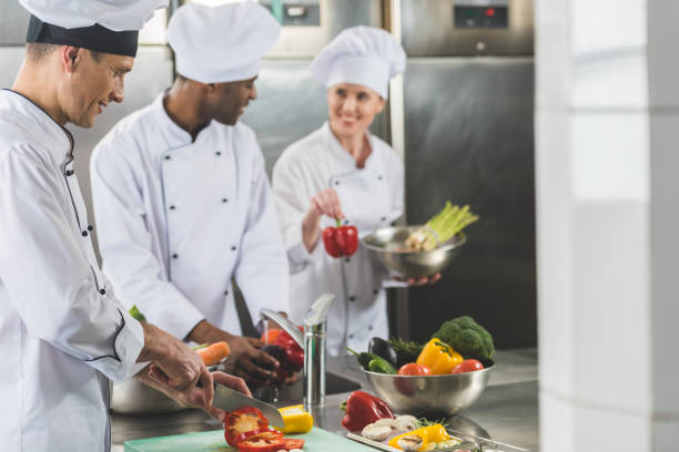 istock smiling multicultural chefs preparing food at restaurant kitchen 941436602