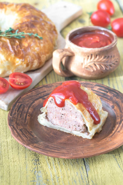 istock Portion of beef Wellington with tomato sauce 941439024