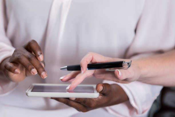 istock Unrecognizable woman gives e-signature on portable information device 941439600
