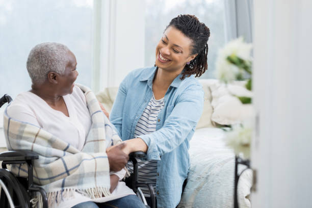 istock Happy woman helps elderly mother 941439620