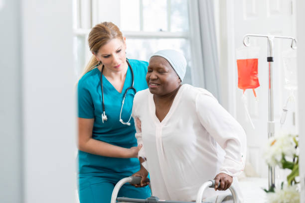 istock Hospital nurse assists senior patient 941439648