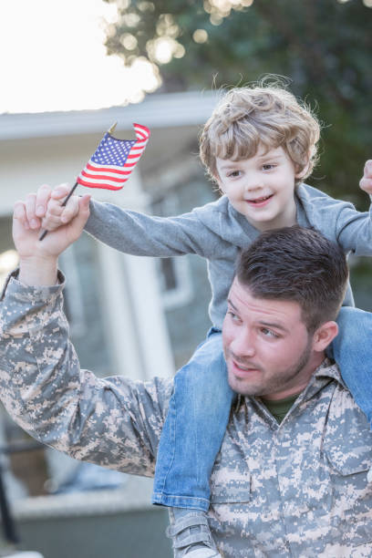 istock Army soldier carries son on shoulders 941439794