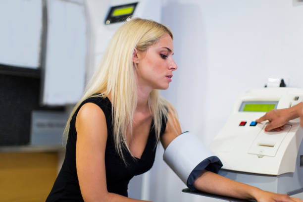 istock Cute young girl measuring blood pressure 941440184