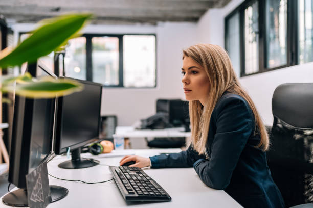 istock Serious blonde businesswoman working on a computer. 941440388