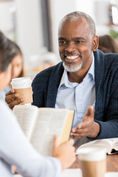 istock Senior man facilitates a Bible study 941440390