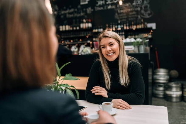 istock Friends having a cup of coffee at the modern cafe. 941440480