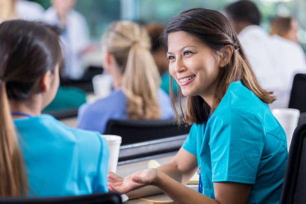 istock Female medical student discusses project with classmate 941440500