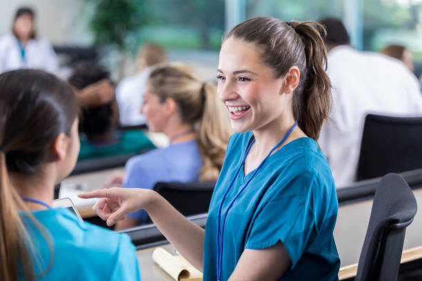 istock Female medical student talks with friend in class 941440506