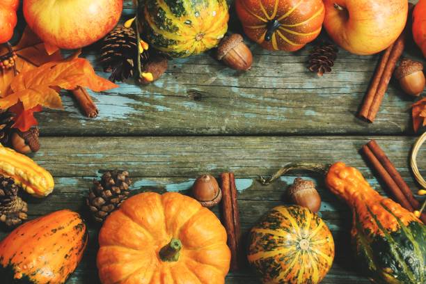 istock Rustic Autumn background with pumpkins apples and fall spices 941443022