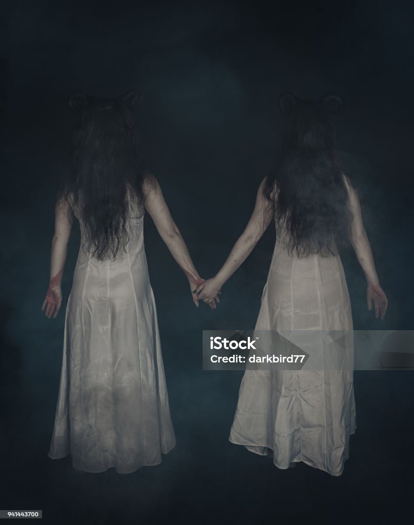 Two terrible ghost with horns on dark. Back pose Two terrible ghost with horns on dark background. Back pose Spooky Stock Photo