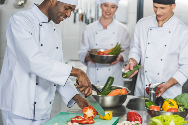 istock multicultural chefs cooking salad at restaurant kitchen 941446350