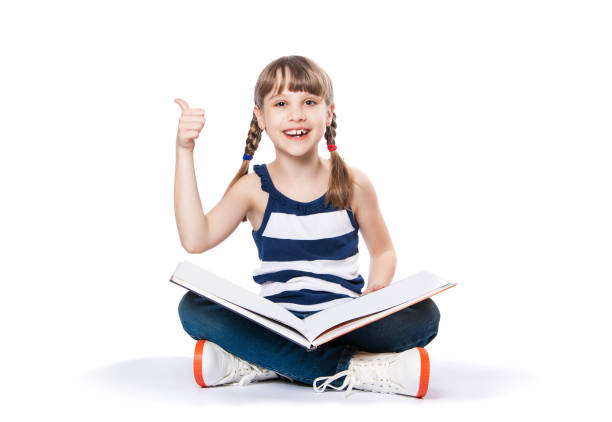 istock girl reading a book on white background. 941450550