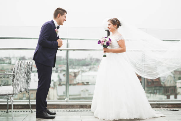 istock Gorgeous wedding couple posing in the old city 941450904