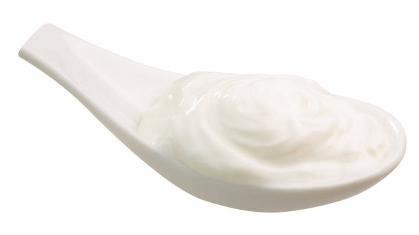istock Spoonful of sour cream, yoghurt, paths 941455712