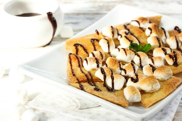 istock Dessert Nachos with Toasted Marshmallows drizzled with chocolate sauce 941456084