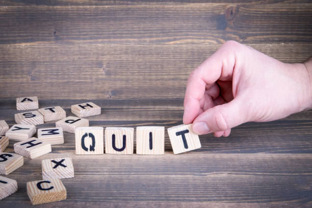 istock Quit. Wooden letters on the office desk 941462152