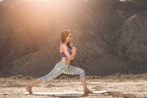 istock Hispanic Women Doing Yoga In The Desert 941468936