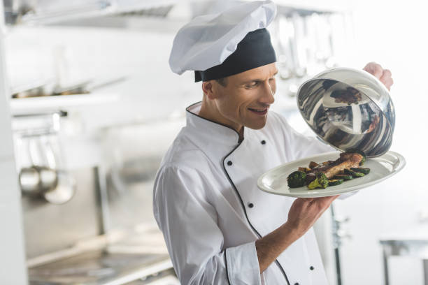 istock happy chef looking at cooked meal at restaurant kitchen 941468950