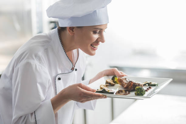 istock attractive chef sniffing cooked steak at restaurant kitchen 941477368