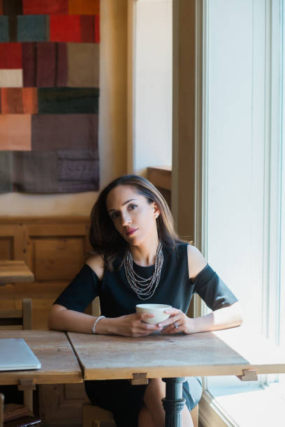 istock Thoughtful businesswoman sitting at cafe table 941478370