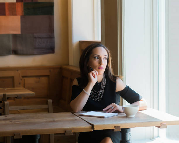 istock Thoughtful businesswoman sitting at cafe table 941478380