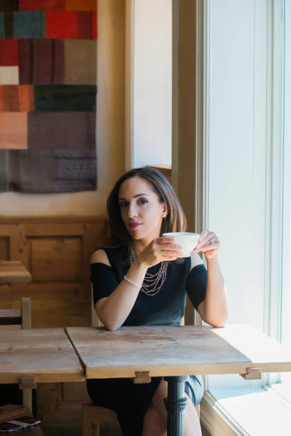 istock Thoughtful businesswoman sitting at cafe table 941478396