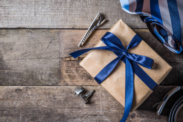 istock Father's day concept - present, tie on rustic wood background 941480900
