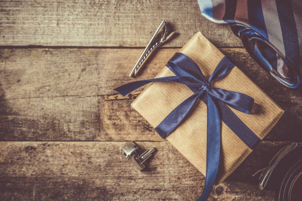 istock Father's day concept - present, tie on rustic wood background 941480928