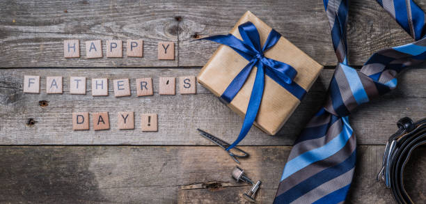istock Father's day concept - present, tie on rustic wood background 941481152