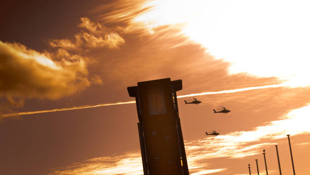башня с вертолетами, летящими за ним на закате - third place flash стоковые фото и изображения