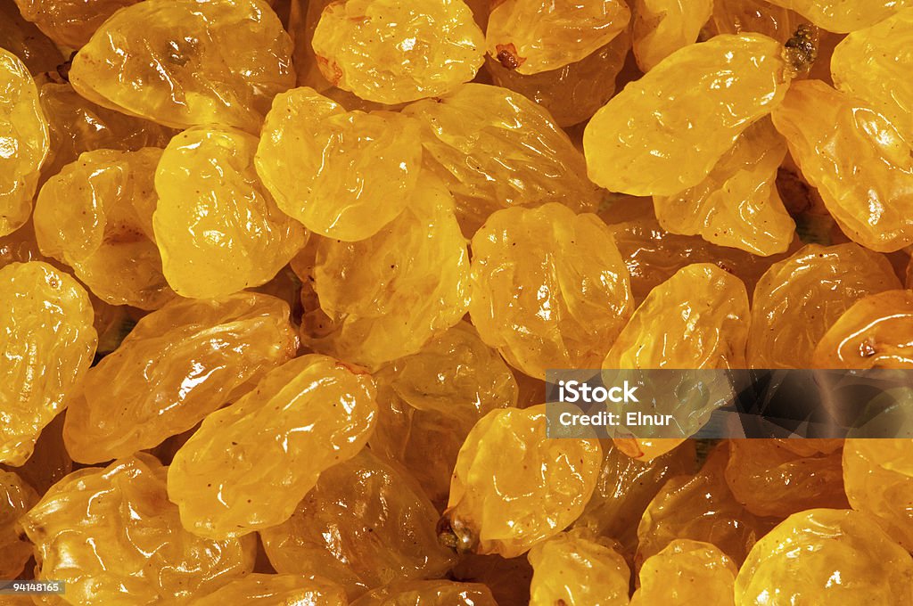 Background made of yellow dried raisins  Backgrounds Stock Photo