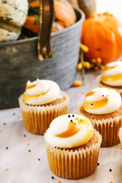 istock Mini Pumpkin spice cupcakes on autumn background, selective focus 941484318