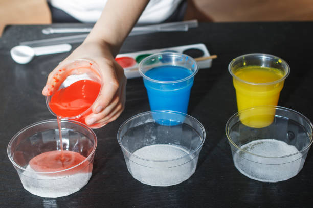 istock Children make experiments with paint and artificial snow 941488950
