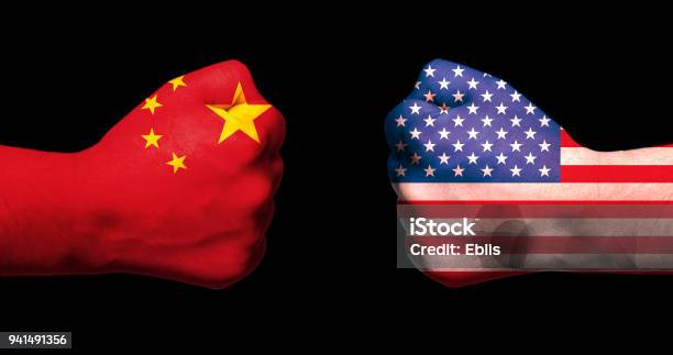 Flags Of Usa And China On Two Clenched Fists Facing Each Other On Black Background Usa China Trade War Concept Stock Photo - Download Image Now