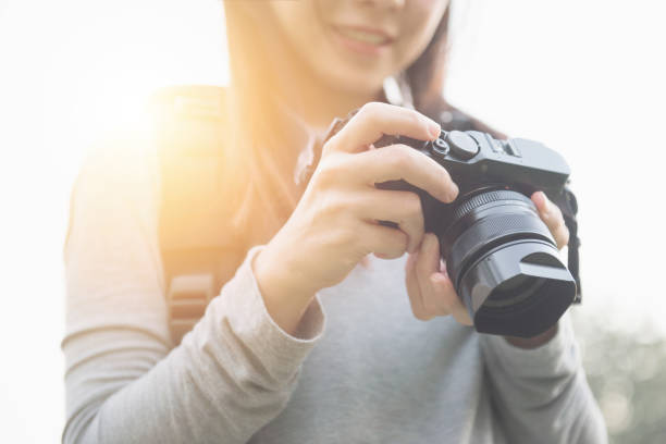 istock Traveler hold mirrorless camera in his hands. 941491820