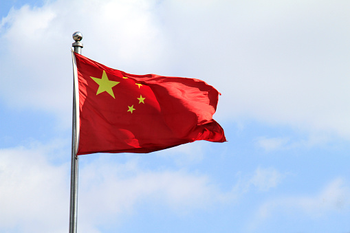 Chinese flag waving in the wind on a sunny day