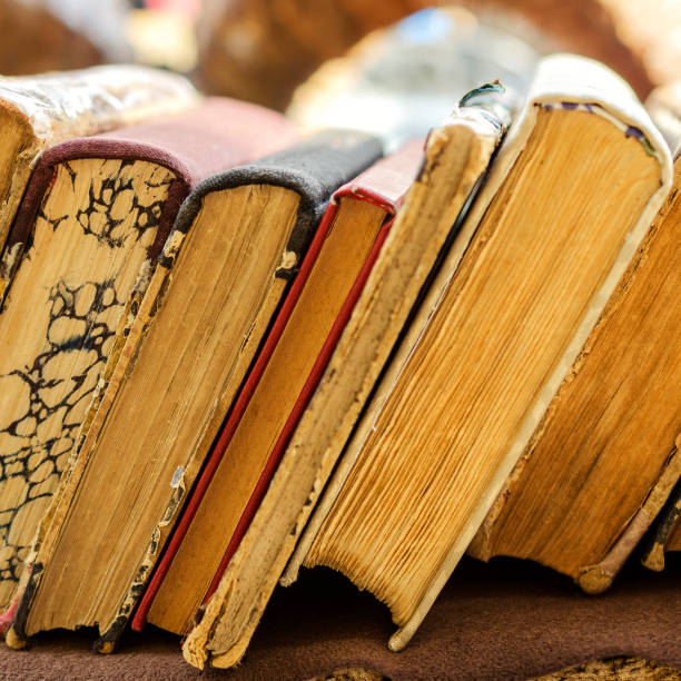 istock Old antiquarian books stand horizontally in a row. Front view. Selective focus. 941495922