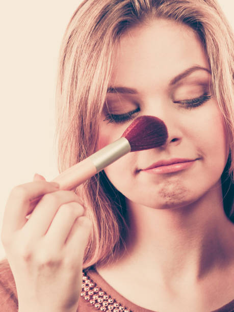 istock Woman holding make up brush 941496856