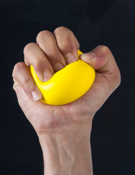 Hand Squeezing Stress Ball stock photo
