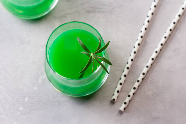 Green alcohol cocktail with apple and rosemary.