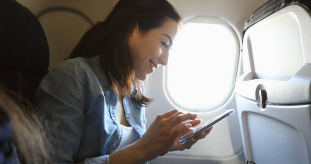 istock Woman posts to social media on airplane before take off 941504578